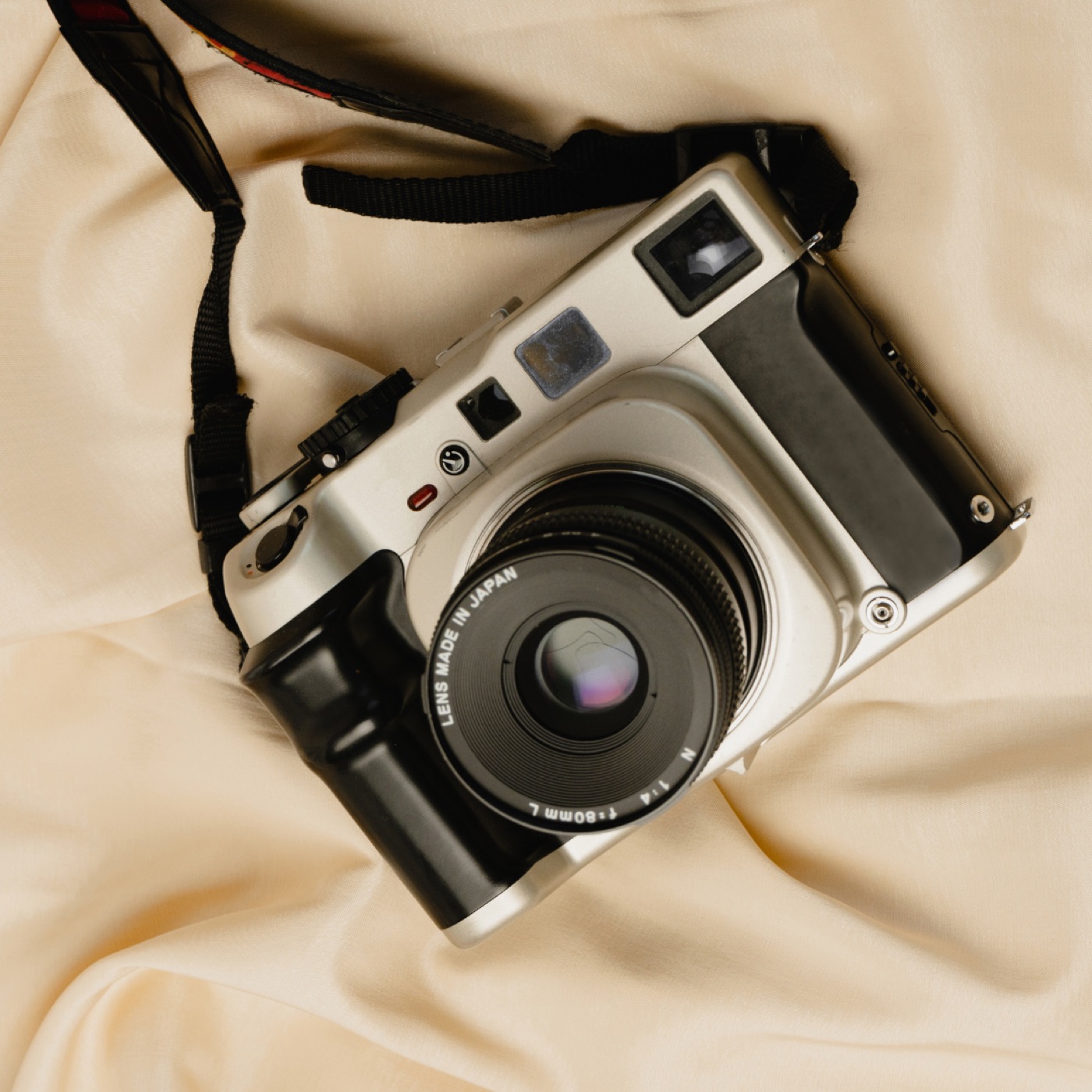 A film camera resting on linen