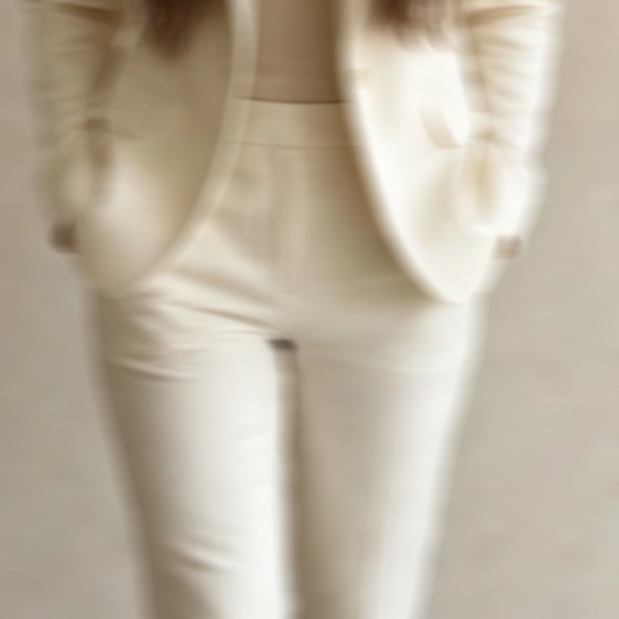 A close up of a cream tailored suit