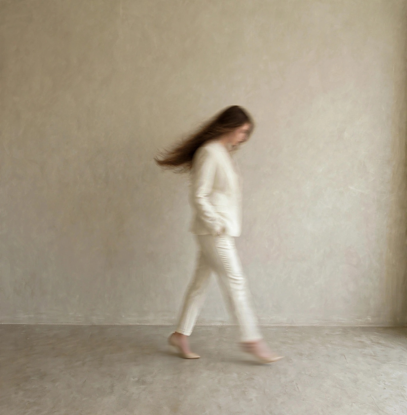 Erin Jaeckle walking in a cream suit