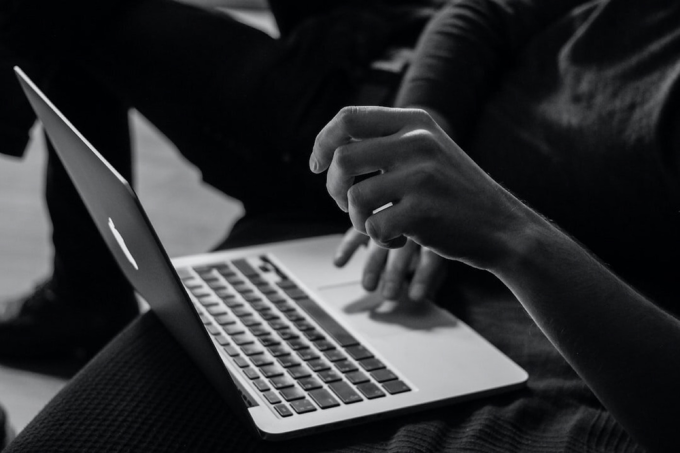 Hands typing on a laptop